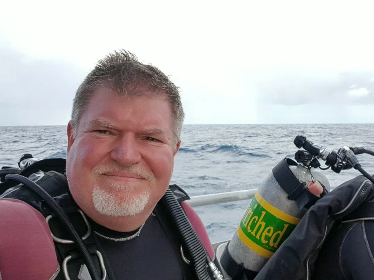 Roger Lawrence in scuba gear on a dive boat